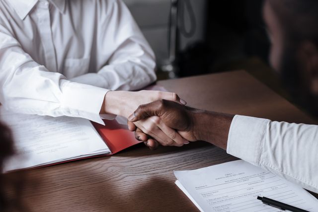 business handshake over documents